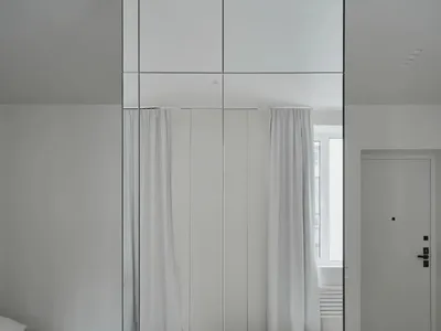Modern bathroom with white walls, floor, and glass wall