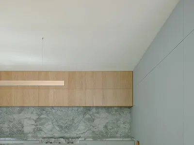 A modern kitchen with marble countertops and minimalist design.