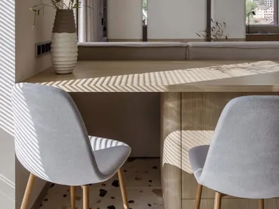 Modern Scandinavian interior design featuring minimalist furniture, natural wood accents, and terrazzo flooring.