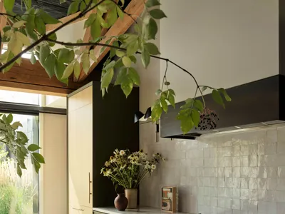 A modern kitchen featuring marble countertops and cabinets adorned with metal accents.