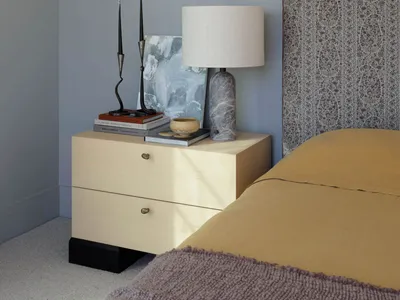 A minimalist bedroom featuring wood mix materials, including a bed with a floral-patterned headboard, a wooden nightstand, an