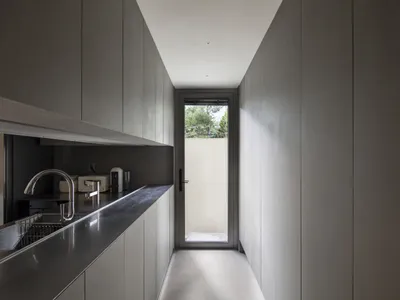 A sleek, modern kitchen with metallic countertops and minimalist design.