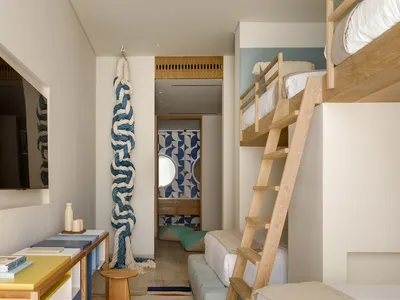 A modern Scandinavian apartment with light wood furniture, colorful textiles, and natural fabrics placed in the interior desi