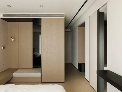 A minimalist bedroom with wooden walls, flooring, and furniture.