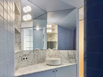 Modern minimalist bathroom with blue tiles and white marble accents