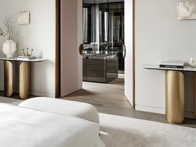 A minimalist bedroom with neutral tones, wooden floors, and marble accents.