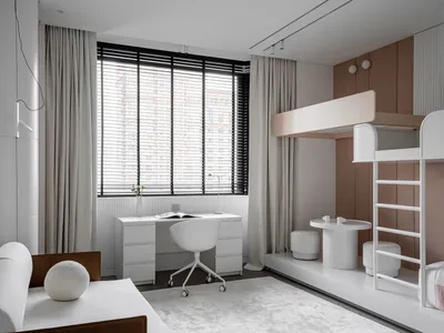 A modern home office space featuring a minimalist design with neutral colors, a desk, and a comfortable seating area with a b