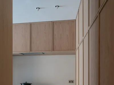 Modern kitchen with sleek wooden cabinets and white porcelain countertops