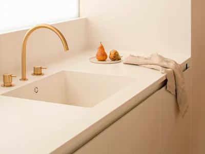 Modern minimalist kitchen space featuring a concrete basin and minimalist design.