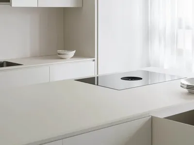 Modern minimalist white kitchen with glass cabinets and stainless steel appliances.