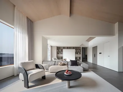 A minimalist living room featuring a concrete flooring.
