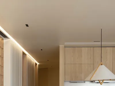 Modern kitchen with wooden paneling and a minimalist design.