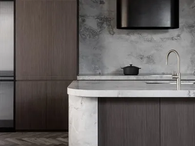 Modern industrial kitchen with a marble countertop, wooden cabinets, and concrete walls.