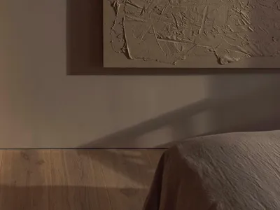 A textured wall in a minimalist bedroom setting.