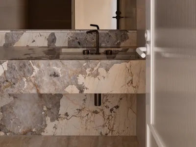 A modern bathroom with a marble countertop and an arch-shaped window.