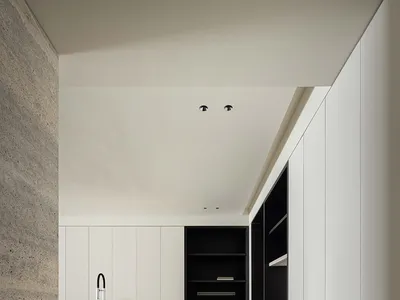 Minimalist residential kitchen featuring textured concrete kitchen island