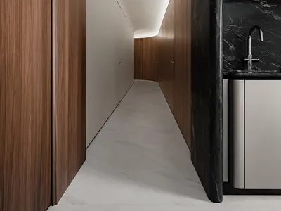 Modern minimalist kitchen featuring white marble cabinets and a black patterned backsplash.