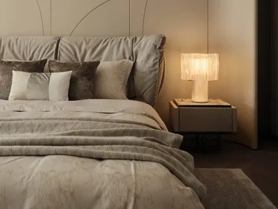 A modern bedroom featuring a comfortable bed with fabric bedding, surrounded by a minimalist design and ambient lighting.