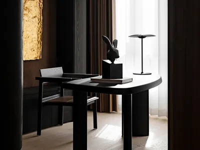 A modern home office featuring a black wooden desk with a rabbit sculpture and a lamp.