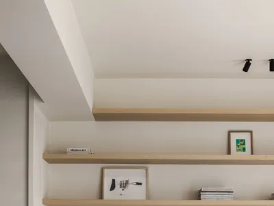 A modern home office with wooden shelves and a woven chair.