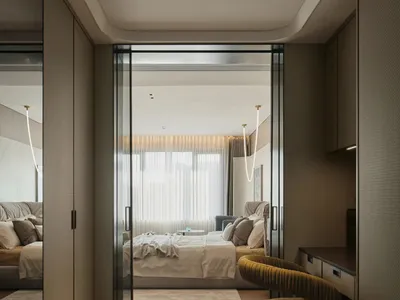 A modern minimalist bedroom with wooden flooring, upholstered furniture, and glass windows.