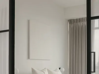 Minimalist bedroom featuring a bed adorned with black and white textiles, positioned near tall, closed drapes.