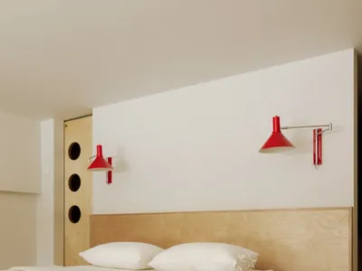 Minimalist bedroom featuring a floating bed supported by wooden walls.