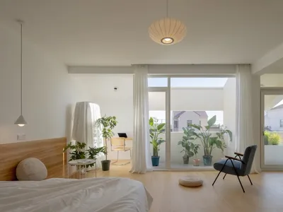 A modern bathroom with wooden accents and a large window overlooking the balcony.