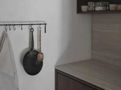 Modern minimalist kitchen featuring concrete countertops and wooden cabinets.