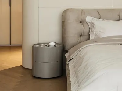 A minimalist bedroom with a circular light fixture illuminating the scene.