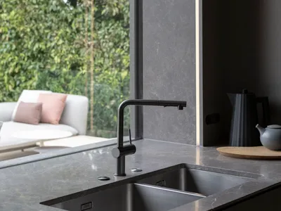 Modern kitchen with marble countertop and stainless steel sink