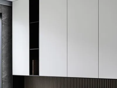 A minimalist bedroom with wooden walls and floor, featuring a bed with white linens and a speaker on a stand.
