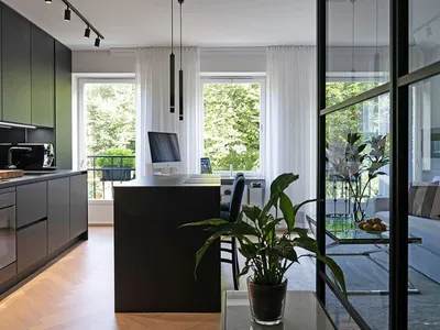 Modern kitchen featuring metallic cabinets and glass elements.