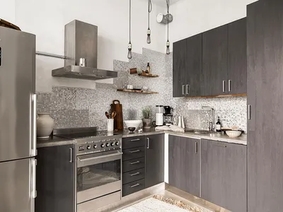 Modern kitchen featuring a stone backsplash with stainless steel appliances and dark cabinets.