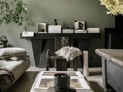 A modern industrial living room featuring rustic wooden furniture, stone accents, and metal elements.