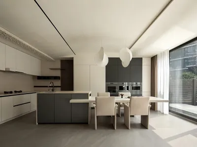 A modern kitchen with stone countertops, white cabinets, and stainless steel appliances.