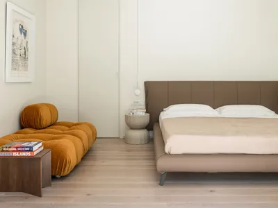 A modern bedroom featuring a leather bed.