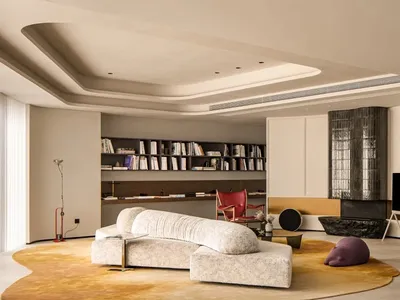 A minimalist living room with a modern sofa, bookshelf, and television.