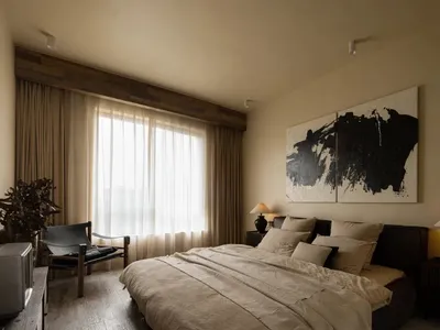 Modern minimalist bedroom featuring neutral tones in textures and textiles, with a large abstract black and white artwork and
