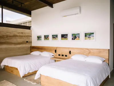 Minimalist bedroom featuring wooden furniture and white bedding