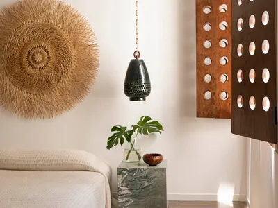 A minimalist bedroom featuring wooden textures and a natural wood finish.