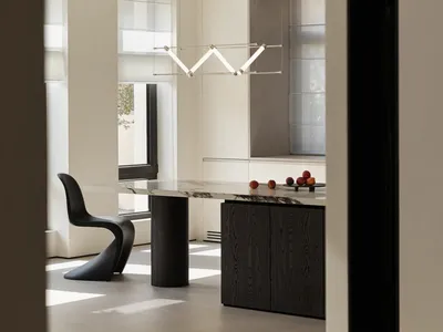 Modern kitchen interior featuring a stone countertop with fruits and minimalist design elements.