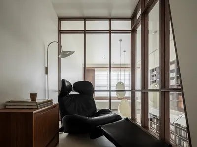 A minimalist living room with industrial design elements, featuring metal furniture and a floor lamp.