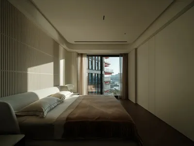 Modern minimalist bedroom featuring a bed with wooden frame, glass window, and fabric bedding.