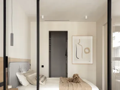 Modern minimalist bedroom with wood floor and light bedding.