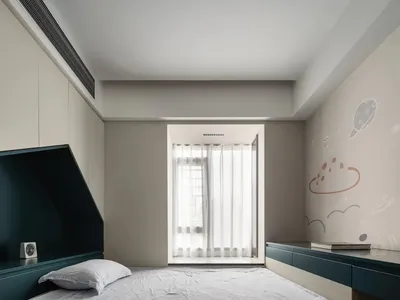 A modern children's bedroom with white walls, a single bed, and a space-themed wall mural featuring planets and clouds.