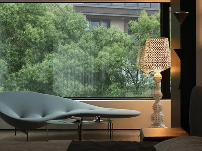 A modern bedroom featuring a glass window with a view of green trees outside.