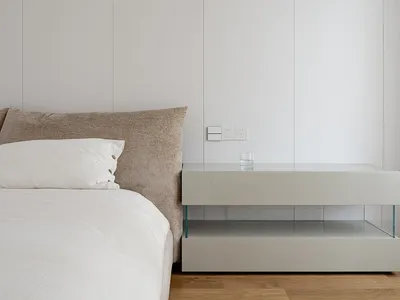 A modern, minimalist bedroom featuring neutral tones and clean lines, showcasing contemporary furniture design.