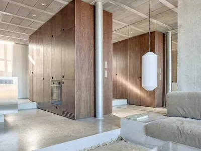A minimalist kitchen with concrete finishes and an open-plan design.