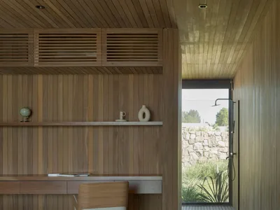 A modern home office featuring wooden walls and a desk area.